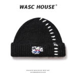 custom solid black shaggy soft wool mix thick rib skull cap, wide fold cuff, diagonal irregular white raw hand topstitch, rectangular panda graphic color text sew tag street hip hop winter hat