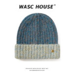 custom teal blue mixed marled wool blend thick rib skull cap, contrast light cream heather fold cuff, small engraved vintage gold snap button minimal outdoor winter hat