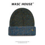 custom teal blue mixed marled wool blend thick rib skull cap, contrast light cream heather fold cuff, small engraved vintage gold snap button minimal outdoor winter hat